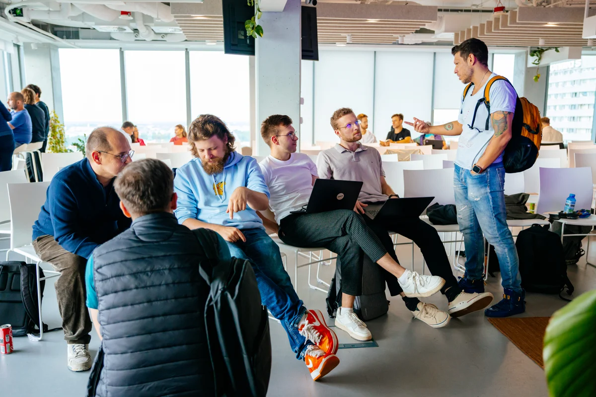 GTM community members talking together between sessions, with laptops open.