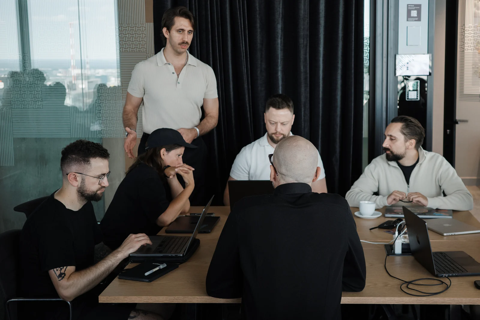 A small group working through a business challenge around a table at GTM Tech Week.